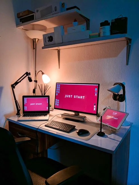 A cozy office setup featuring Christmas decor, a mug, and a laptop screen displaying a website.